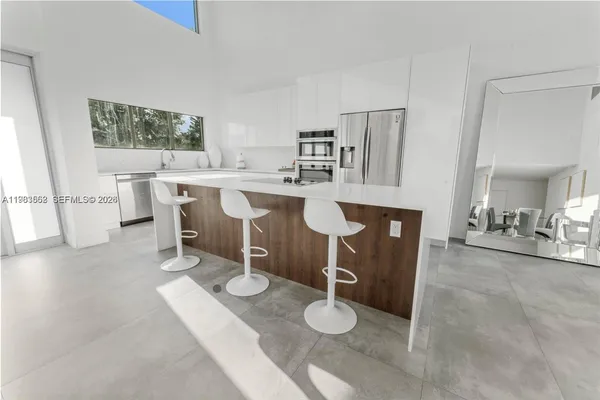 a living room with furniture a window and kitchen view