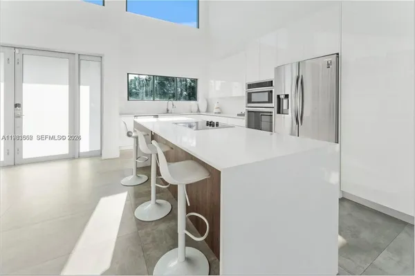 a kitchen with appliances cabinets and a table
