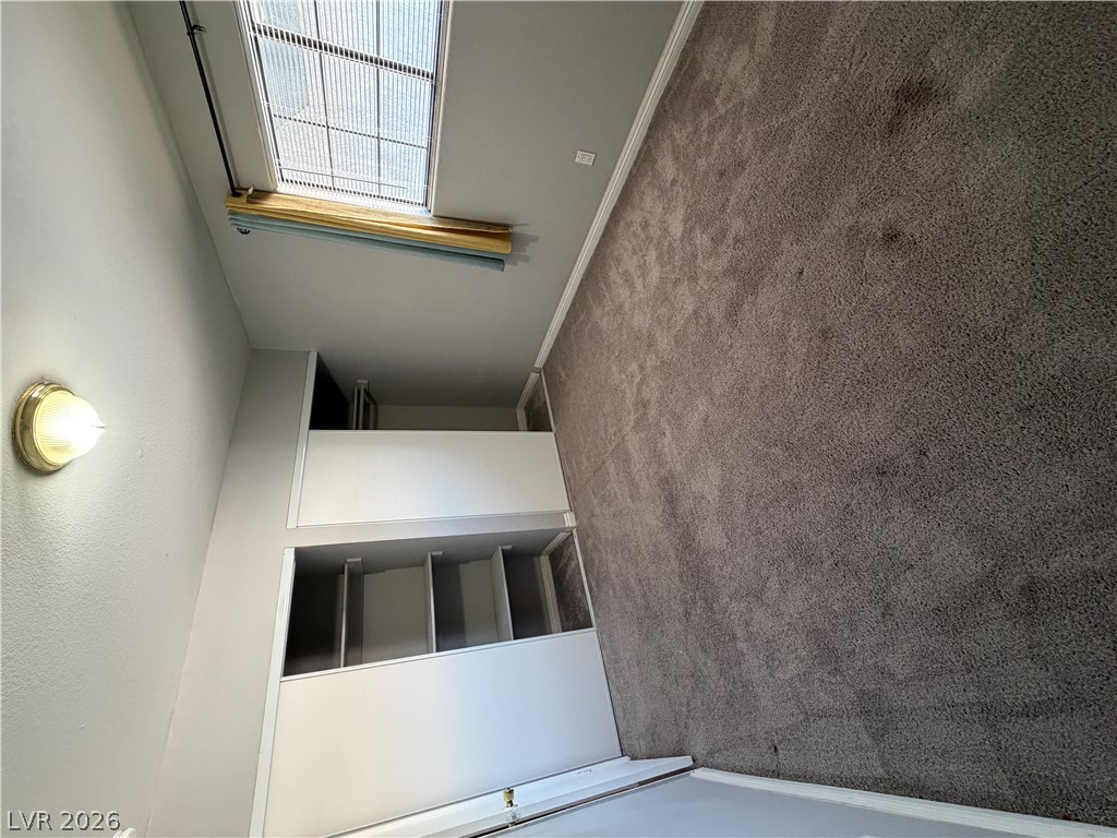 2820 South Sandhill Road, Unit A Las Vegas, NV 89121 - Photo 20 of 26 A well-lit bedroom features plush carpeting and a convenient skylight for natural illumination.