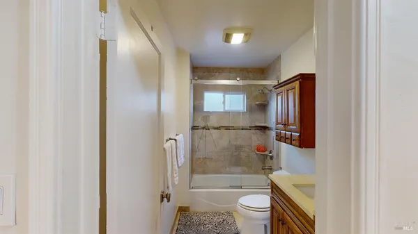 a bathroom with a shower a toilet and a sink