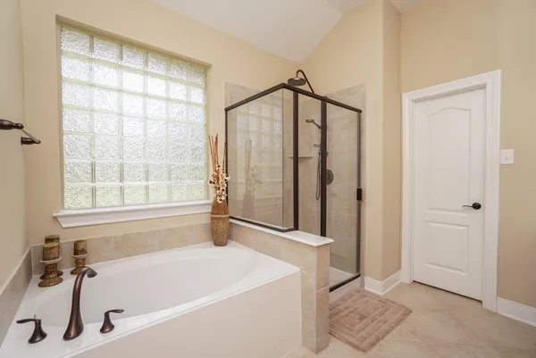 a bathroom with a tub and a shower