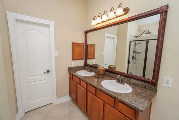 a bathroom with a granite countertop sink and a mirror