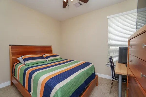 a bedroom with a bed and a chair