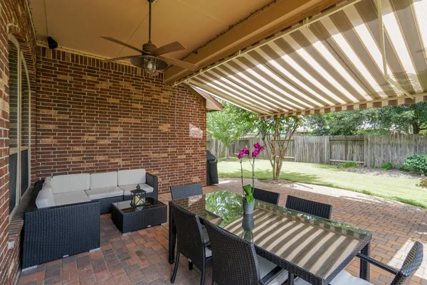 a backyard of a house with yard and outdoor seating
