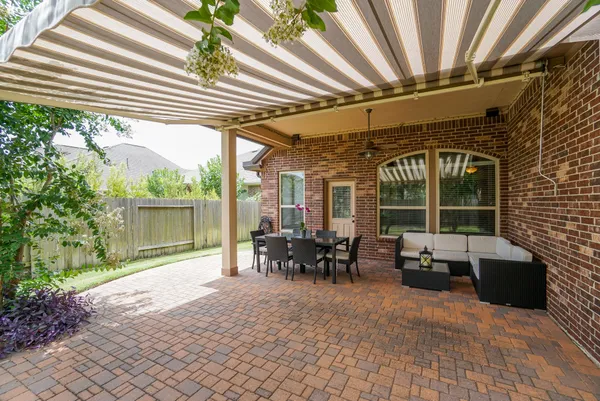 a view of a patio with table and chairs and potted plants