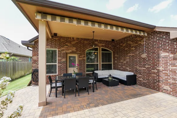 a patio with table and chairs