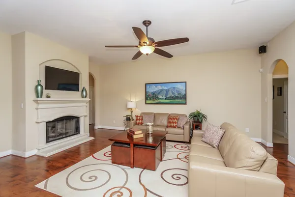 a living room with furniture a fireplace and a flat screen tv