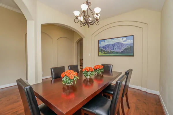 a view of a dining room with furniture and chandelier