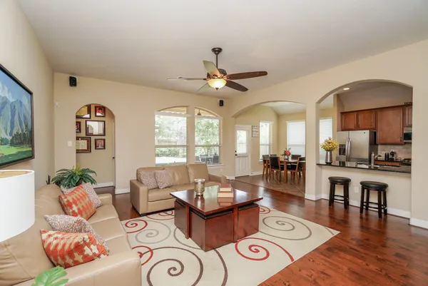 a living room with furniture and wooden floor