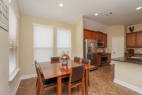 a view of a dining room with furniture and a window