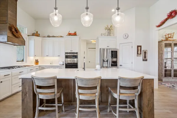 a kitchen with a sink a stove and cabinets
