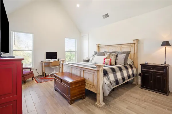 a bedroom with a bed and a chandelier