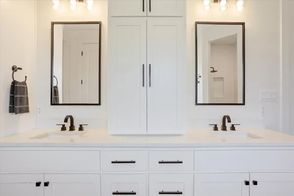a bathroom with a double vanity sink and mirror