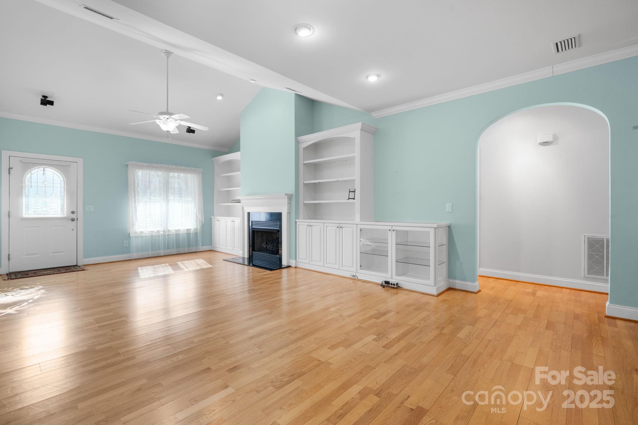 906 3rd St Drive Northeast Conover, NC 28613 - Photo 6 of 47 an empty room with wooden floor fireplace and windows