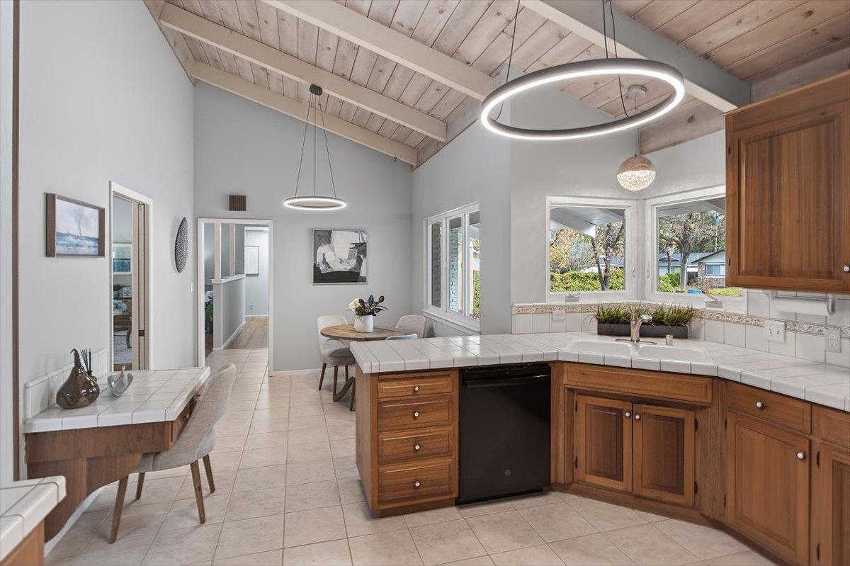 251 Old Adobe Road Los Gatos, CA 95032 - Photo 17 of 40 a kitchen with a sink a stove a dining table and chairs