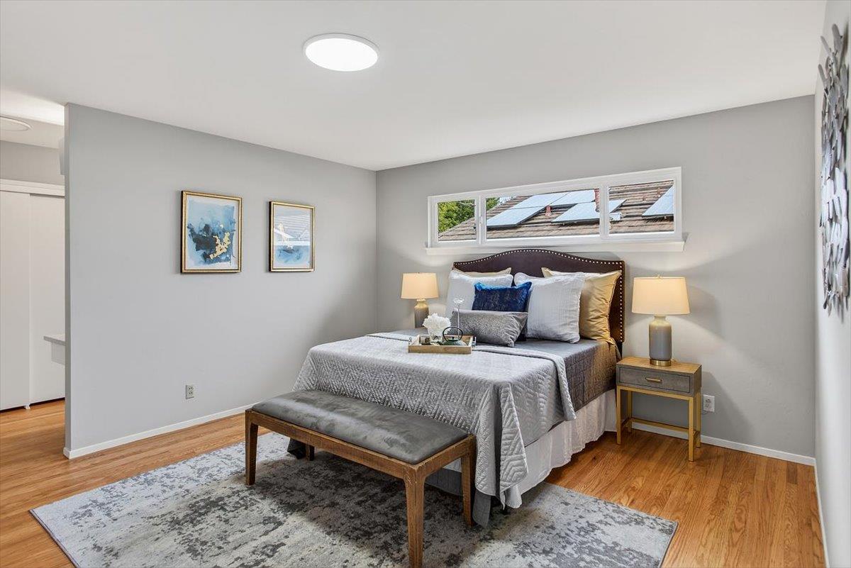 251 Old Adobe Road Los Gatos, CA 95032 - Photo 21 of 40 a bedroom with a bed and a painting on the wall