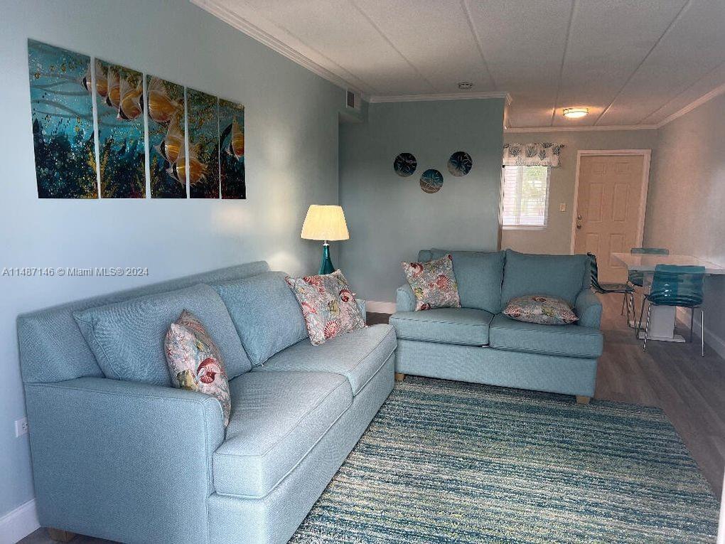 1215 97th Street, Unit 11 Marathon, FL 33050 - Photo 12 of 25 a living room with furniture and a large window