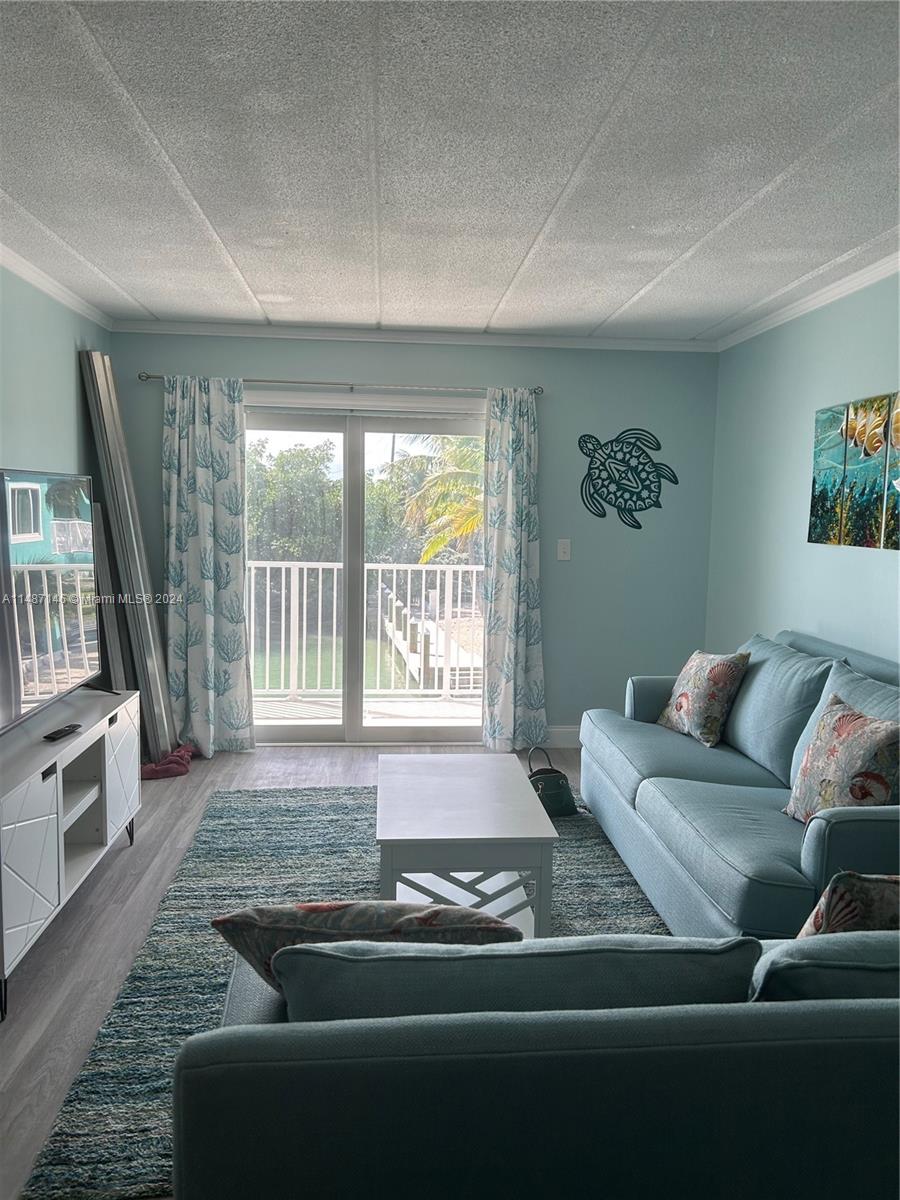 1215 97th Street, Unit 11 Marathon, FL 33050 - Photo 14 of 25 a living room with furniture and a window