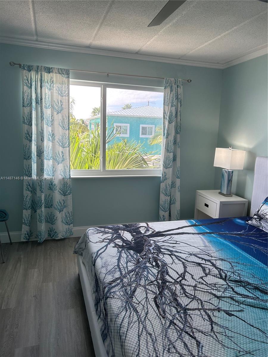 1215 97th Street, Unit 11 Marathon, FL 33050 - Photo 18 of 25 a bedroom with a bed and a window