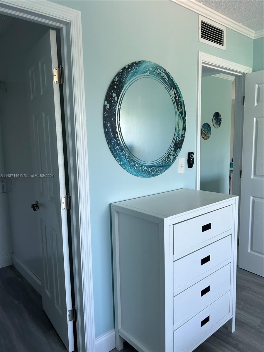 1215 97th Street, Unit 11 Marathon, FL 33050 - Photo 20 of 25 a bathroom with a granite countertop toilet sink mirror and vanity