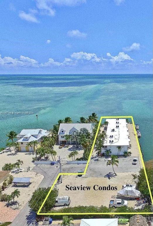 1215 97th Street, Unit 11 Marathon, FL 33050 - Photo 2 of 25 a view of a swimming pool with an ocean view