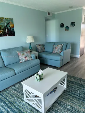 a living room with furniture and a rug
