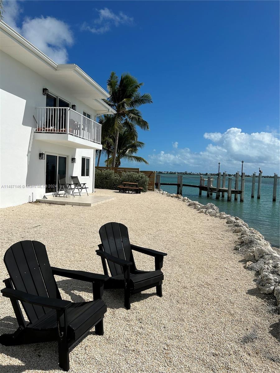 1215 97th Street, Unit 11 Marathon, FL 33050 - Photo 3 of 25 a building outdoor space with patio furniture