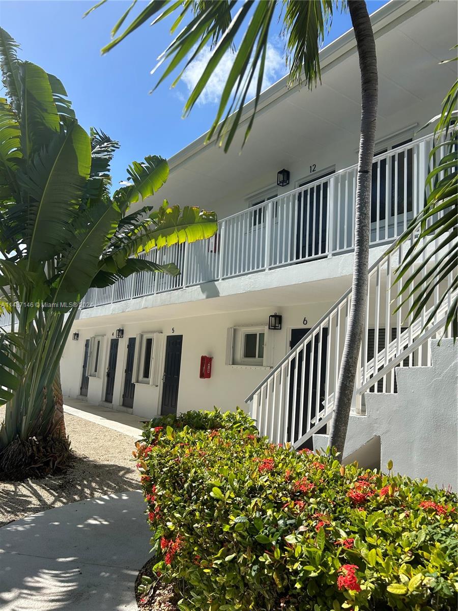 1215 97th Street, Unit 11 Marathon, FL 33050 - Photo 8 of 25 a view of a house with balcony and garden