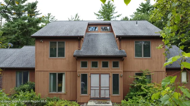 a view of a house with roof and plants
