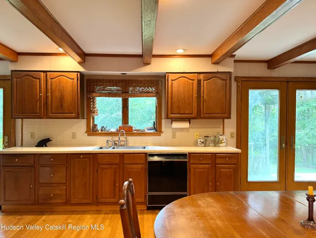 a kitchen with a sink a window and cabinets