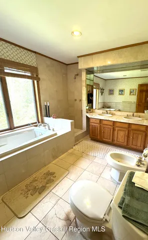 a bathroom with a tub sink and a shower
