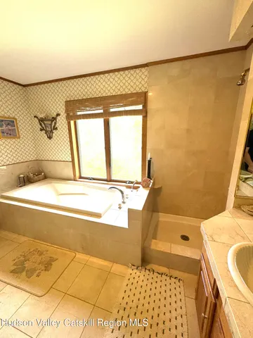 a view of a hallway with wooden floor and windows