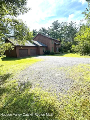 a view of a yard with large trees
