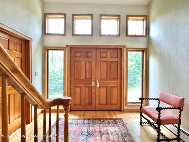view of hall way with furniture and windows