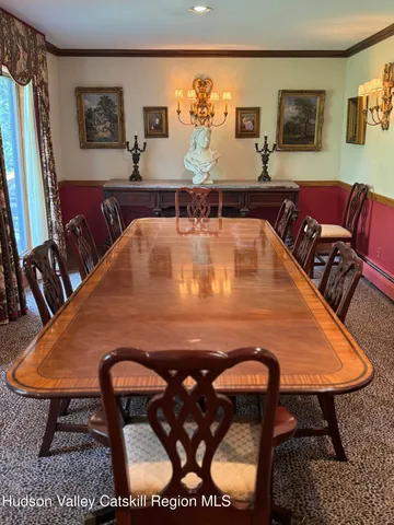 a dining table with chairs and window