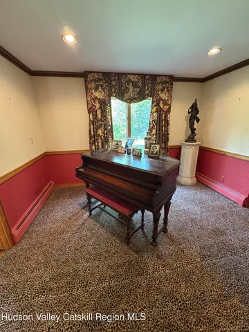 a room with pool table and windows