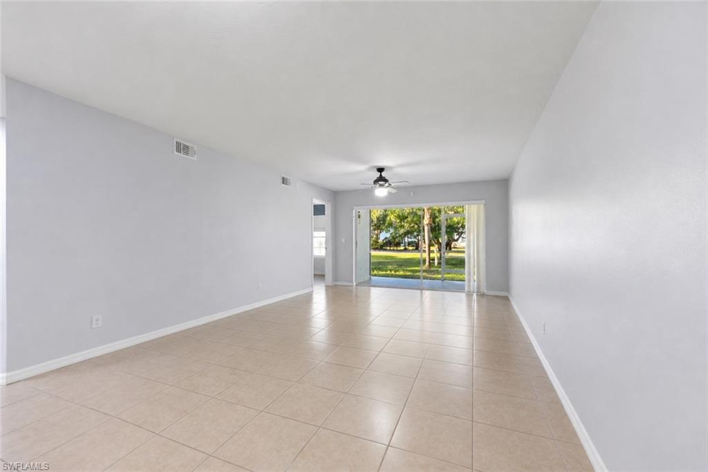 5737 Whitaker Road, Unit C101 Naples, FL 34112 - Photo 15 of 28 an empty room with windows and fireplace