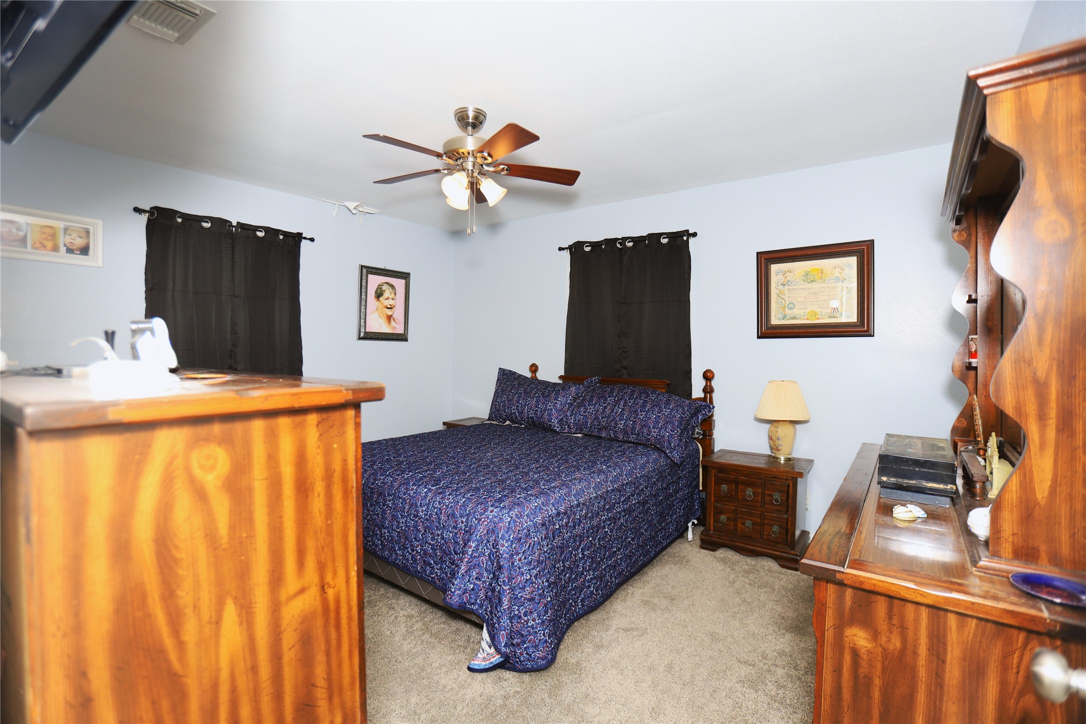 726 West 8th Street Freeport, TX 77541 - Photo 4 of 18 Primary Bedroom – Comfortable retreat with soft carpeting, ceiling fan, and calming wall color.