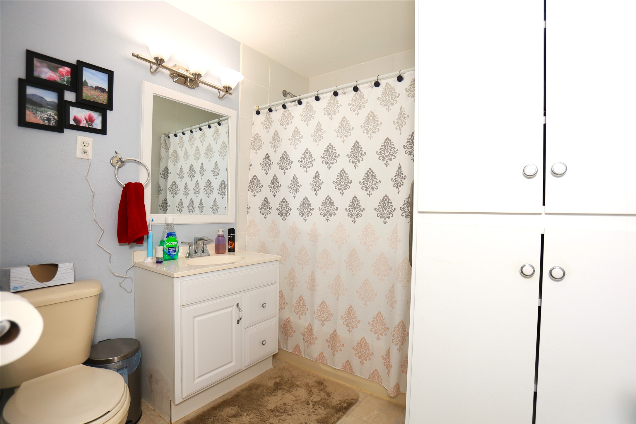 726 West 8th Street Freeport, TX 77541 - Photo 9 of 18 Bathroom 1 – Clean and functional full bath with white vanity, storage cabinet, and tub/shower combo.