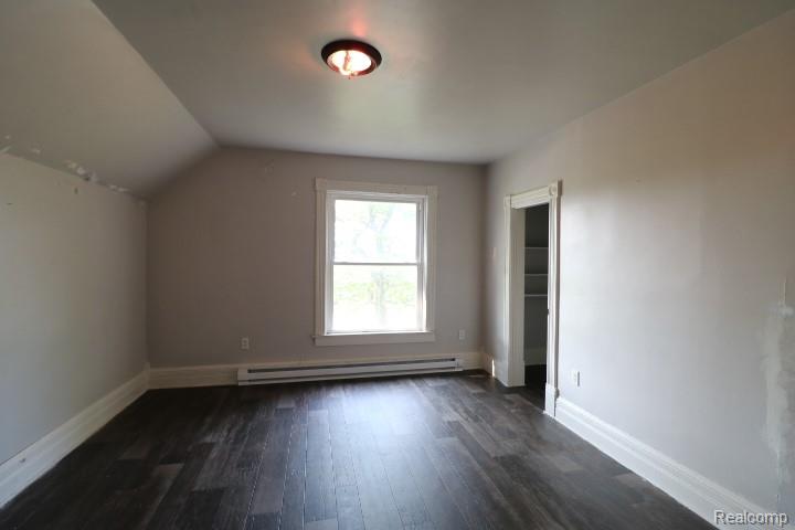 6577 East Deckerville Road Deford, MI 48729 - Photo 18 of 23 Wood-finish flooring, white window trim, and a built-in closet with shelving