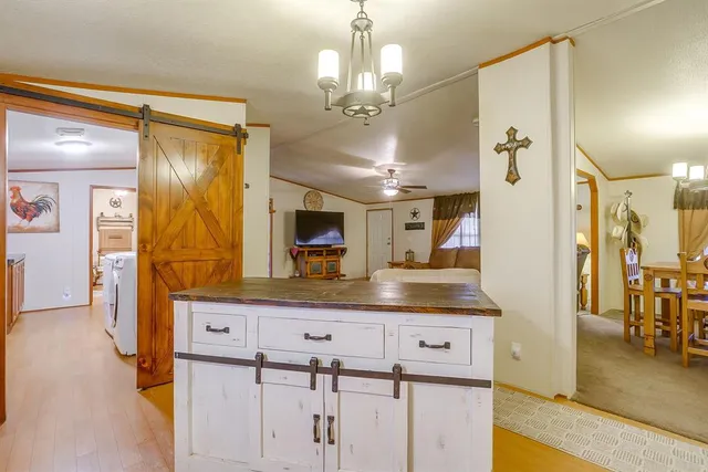 a kitchen with stainless steel appliances granite countertop a sink and a refrigerator