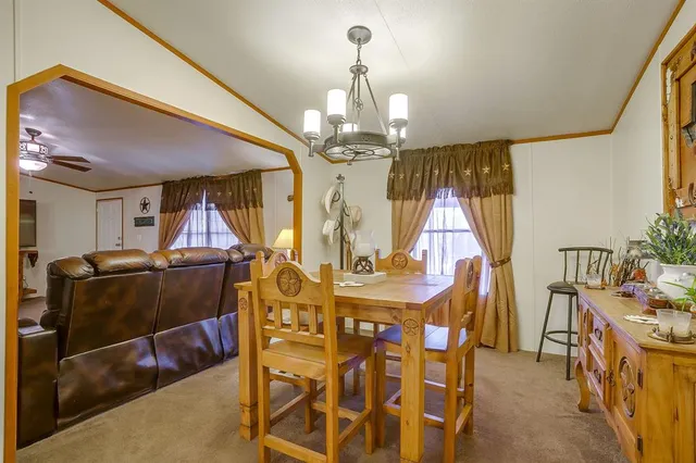 a view of a dining room with furniture and chandelier