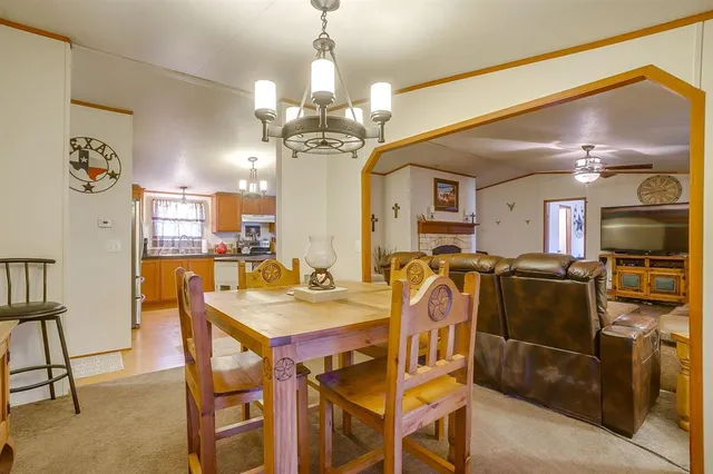 a view of a dining room with furniture and chandelier