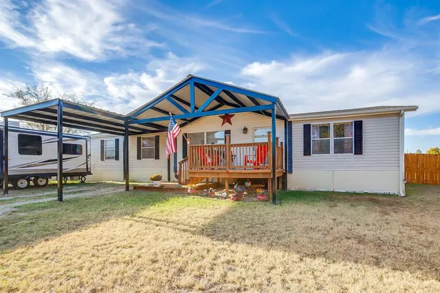 a view of a house with a yard and sitting area