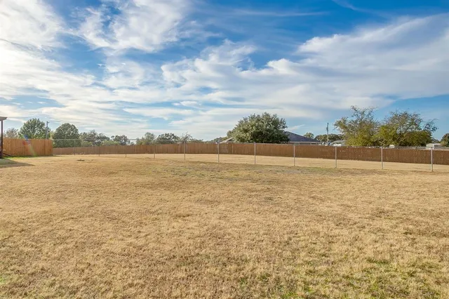 a yellow house with trees in front of it
