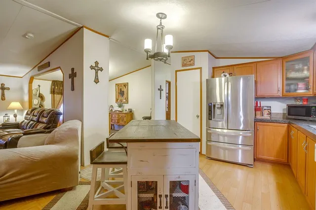 a kitchen with stainless steel appliances granite countertop a refrigerator a stove and a refrigerator