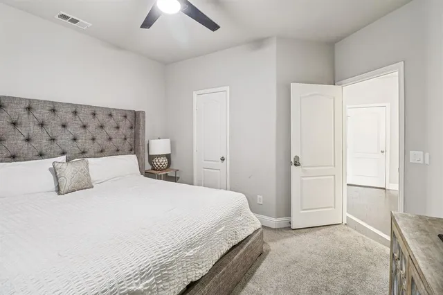 a bedroom with a bed and a ceiling fan