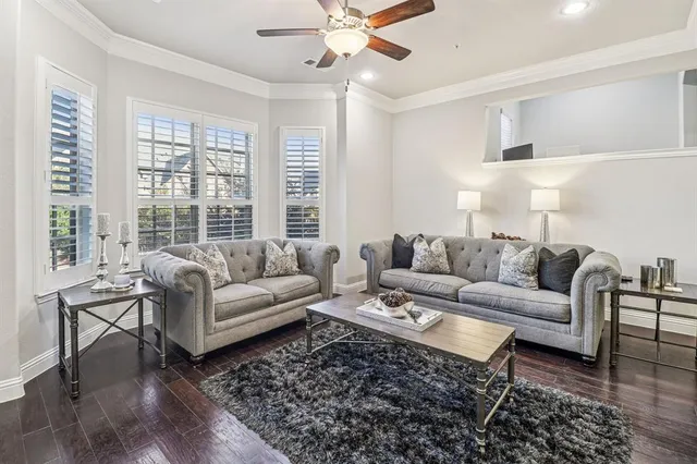 a living room with furniture a large window and a rug