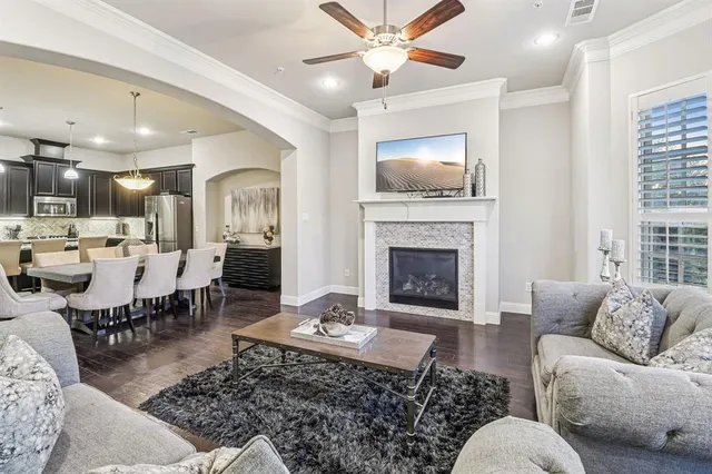 a living room with furniture a flat screen tv and a fireplace