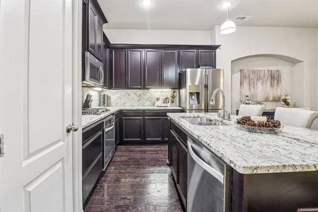 a kitchen with a sink stove and cabinets